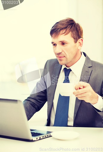 Image of businessman working with laptop computer