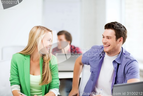 Image of smiling students looking at each other at school