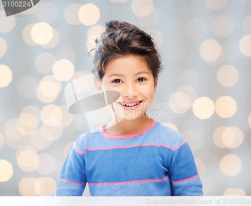 Image of little girl over holidays lights background