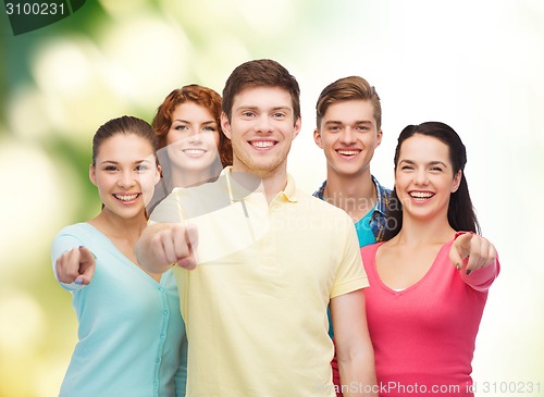 Image of group of smiling teenagers over green background