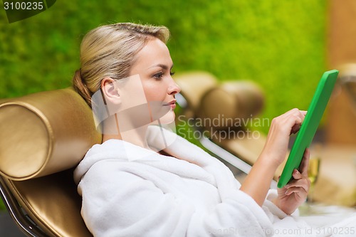 Image of beautiful young woman with smartphone at spa