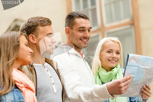 Image of group of friends with map exploring city