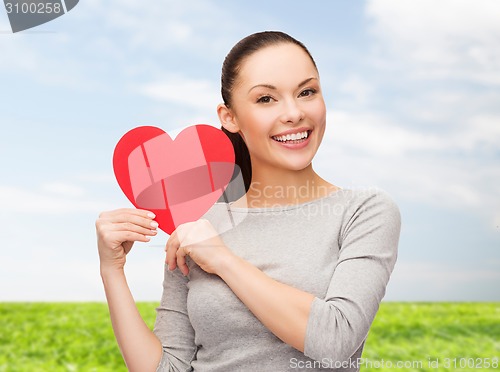 Image of smiling asian woman with red heart