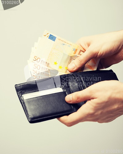 Image of man in suit with euro cash money