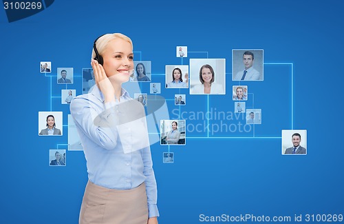 Image of happy female helpline operator with headphones