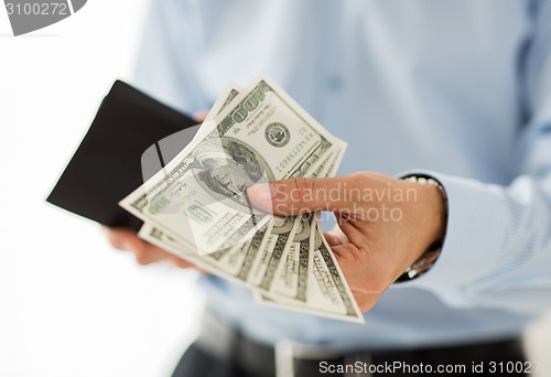 Image of close up of businessman hands holding money