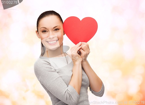 Image of smiling asian woman with red heart