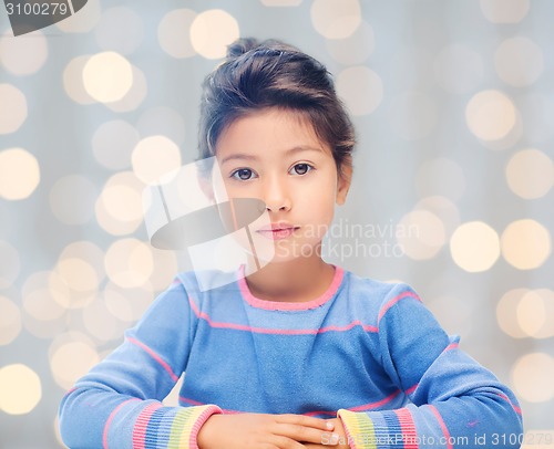 Image of little girl over holidays lights background