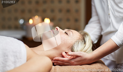 Image of close up of woman having face massage in spa