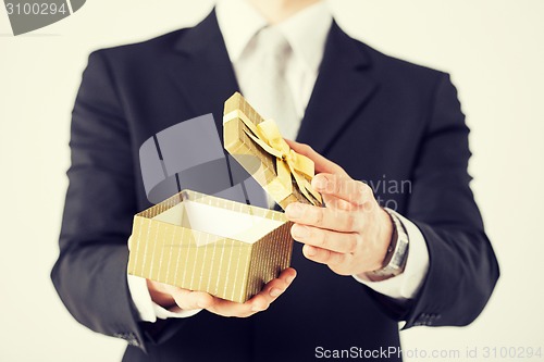 Image of man hands holding gift box