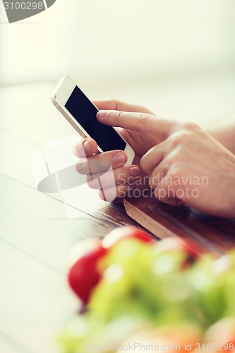 Image of closeup of male hand pointing finger to smartphone