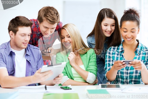 Image of students looking at smartphones and tablet pc