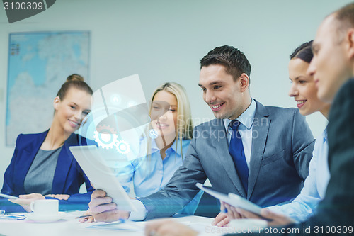 Image of business team with tablet pc having discussion