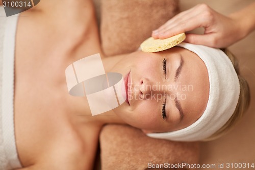 Image of close up of woman having face cleaning in spa