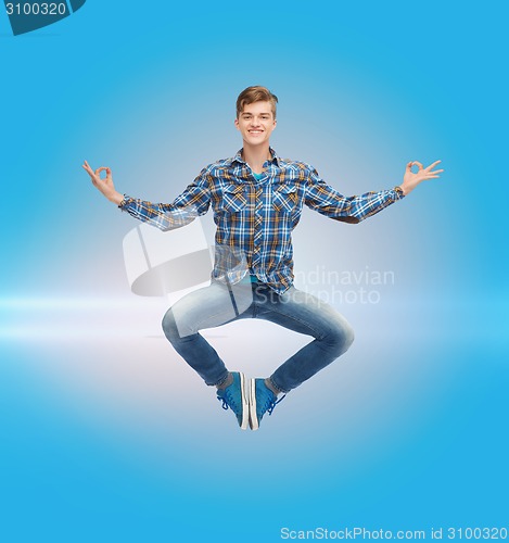 Image of smiling young man jumping in air