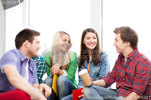 Image of students communicating and laughing at school