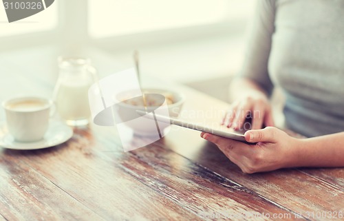 Image of close up of woman reading news from tablet pc