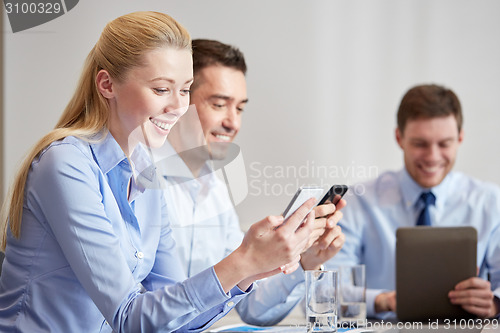 Image of businesspeople with smartphones and tablet pc