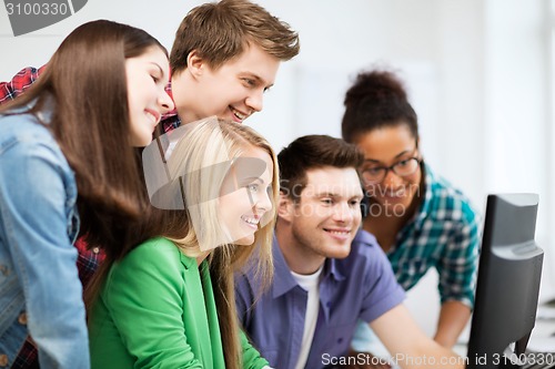 Image of students looking at computer monitor at school