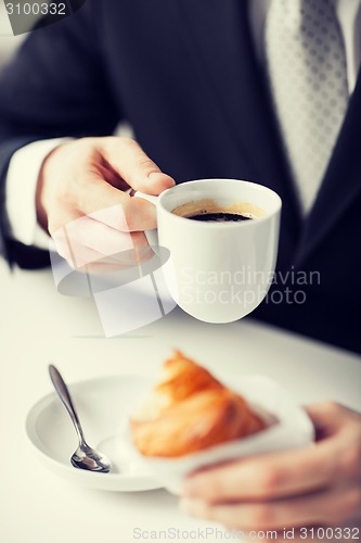 Image of man with tablet pc and cup of coffee