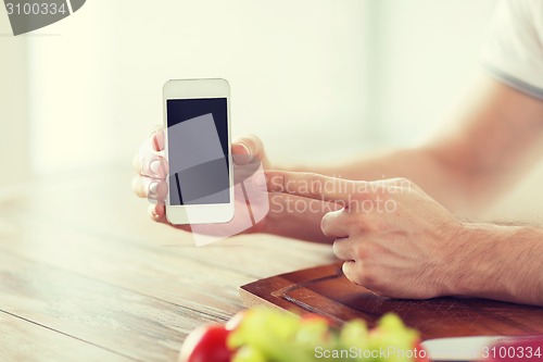 Image of close up of male hands holding smartphone