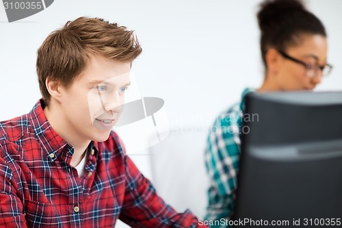 Image of student with computer studying at school