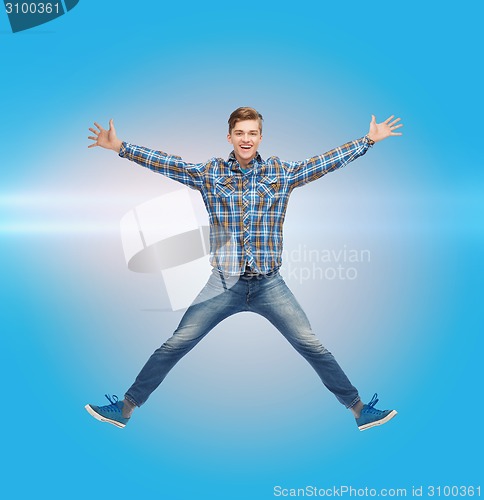 Image of smiling young man jumping in air