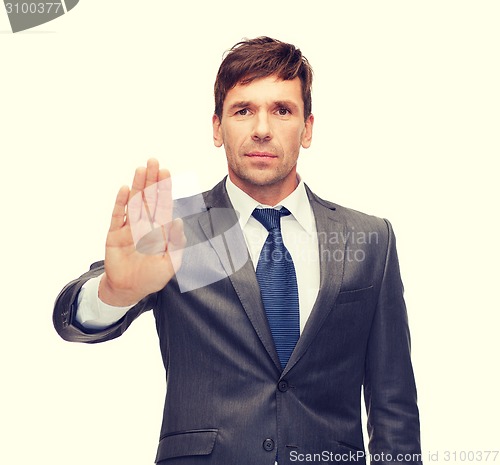 Image of attractive buisnessman making stop gesture