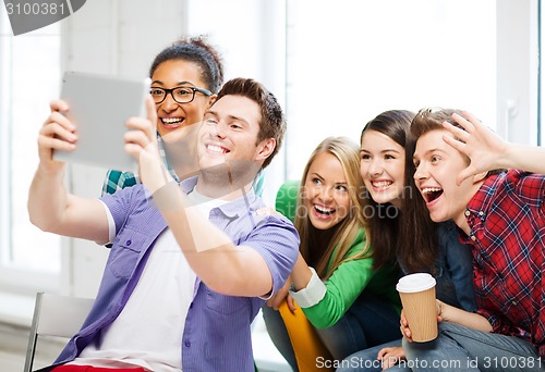 Image of students taking selfie with tablet pc at school
