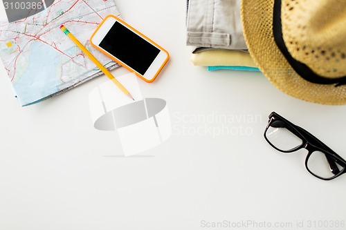 Image of close up of summer clothes and travel map on table