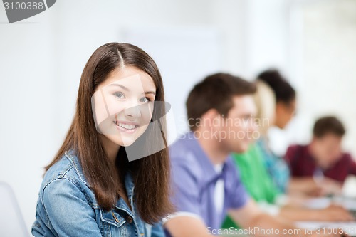 Image of student with computer studying at school