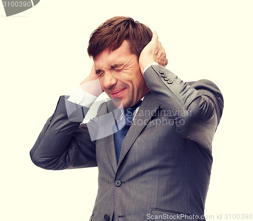 Image of stressed buisnessman or teacher closing ears