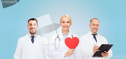 Image of group of smiling doctors with red heart shape