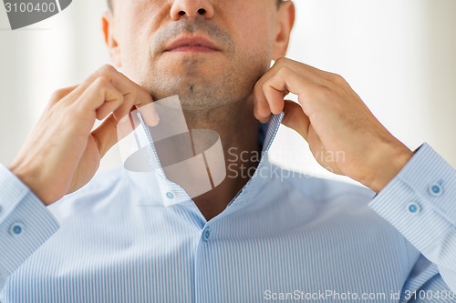 Image of close up of man in shirt dressing 