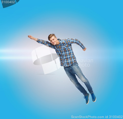 Image of smiling young man jumping in air