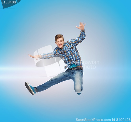 Image of smiling young man jumping in air