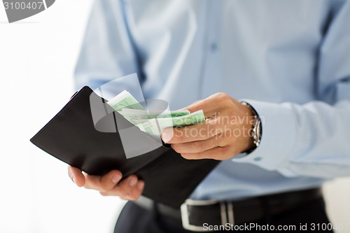 Image of close up of businessman hands holding money