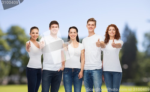 Image of smiling teenagers in t-shirts showing thumbs up