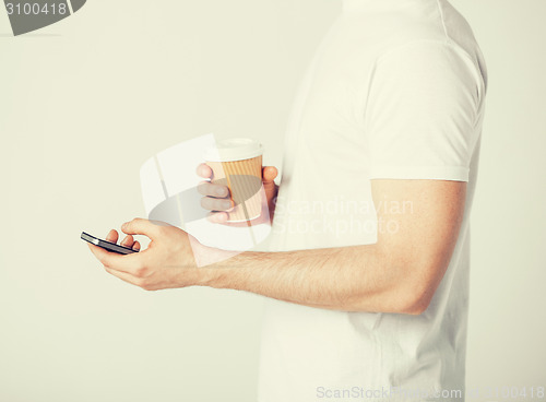 Image of man with smartphone and coffee