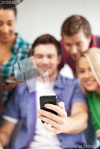 Image of students looking at smartphone at school