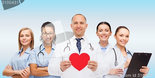 Image of group of smiling doctors with red heart shape