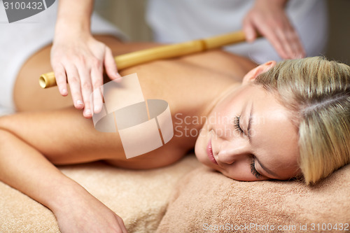 Image of close up of woman lying and having massage in spa