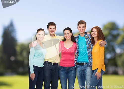 Image of group of smiling teenagers over green park