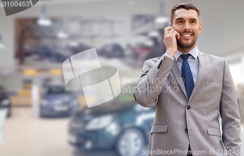 Image of smiling businessman talking on smartphone