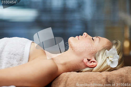 Image of young woman lying in spa