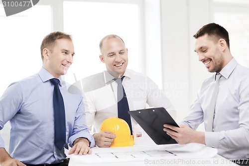 Image of happy team of architects and designers in office