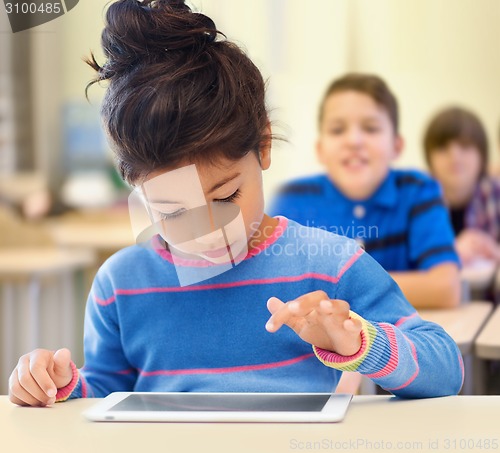 Image of little school girl with tablet pc over classroom