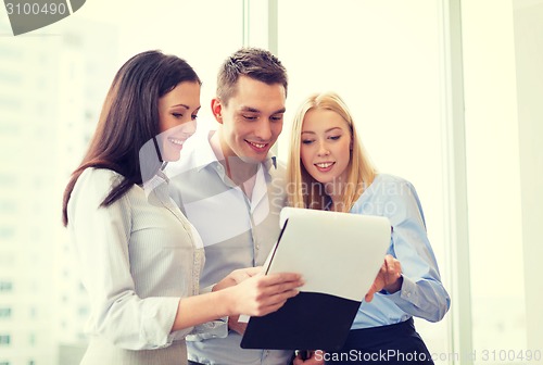 Image of business team looking at clipboard