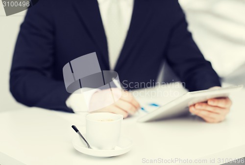 Image of man with tablet pc and cup of coffee