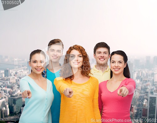 Image of group of smiling teenagers over city background